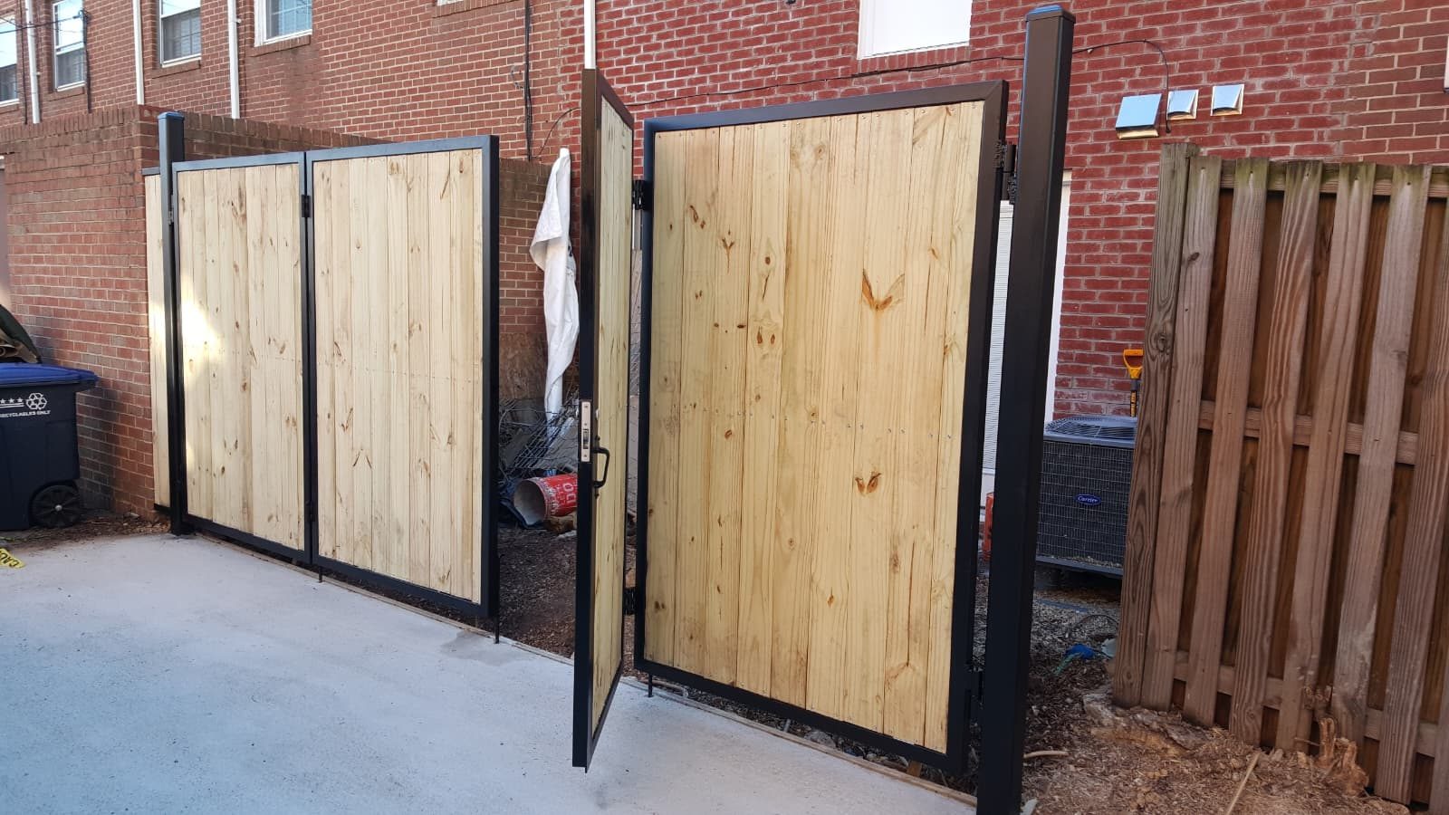 Completed custom wood and metal double gate by NMA Custom Welding & Fabrication